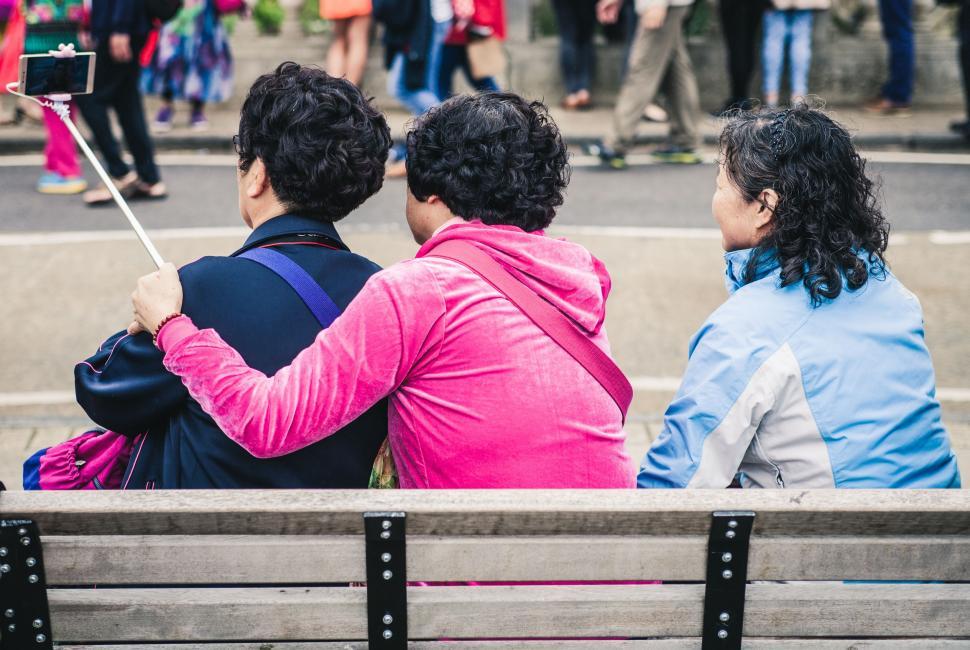 Free Image of Couple Sitting on Top of Wooden Bench 