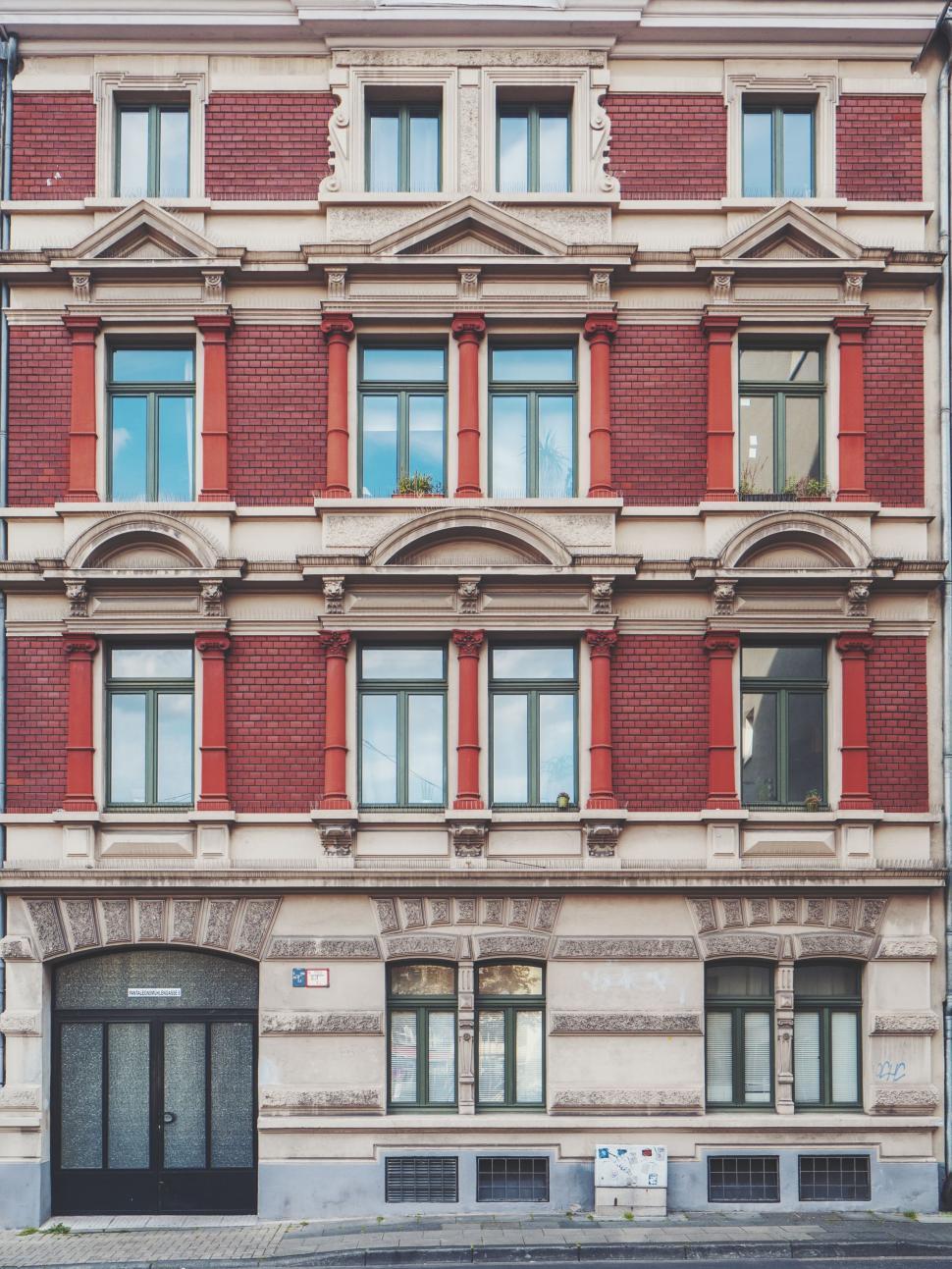 Free Image of Large Building With Red Shutters 