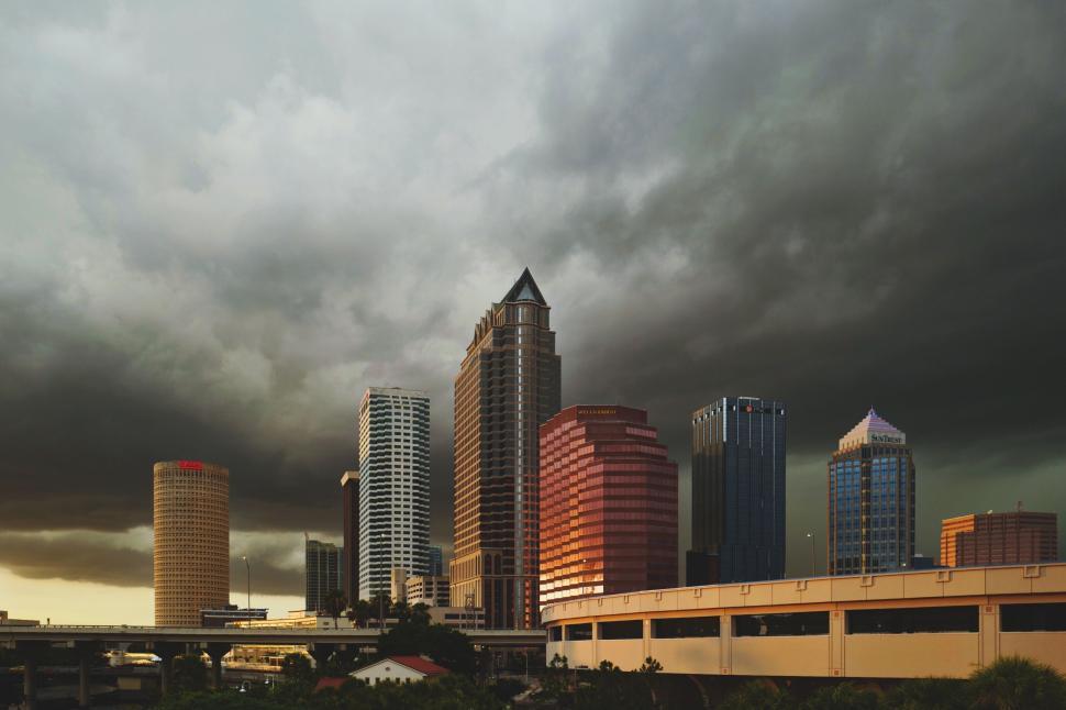 Free Image of Skyline of a City With Tall Buildings Under Cloudy Sky 