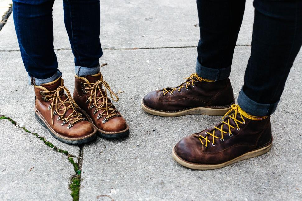 Free Image of Two People Standing Together on a Sidewalk 