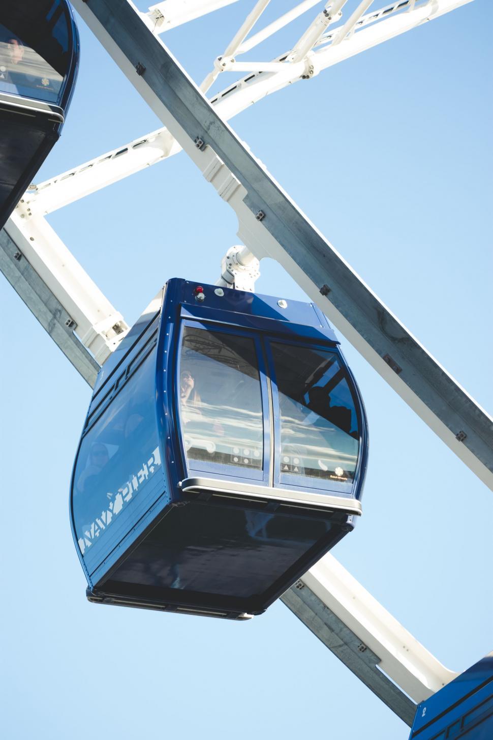 Free Image of Blue and White Ferris Wheel Against Blue Sky 