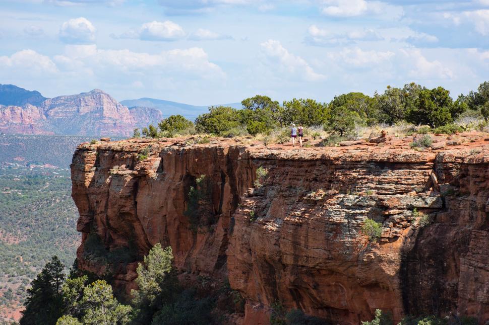 Free Image of Man Standing on Cliff Overlooking Valley 