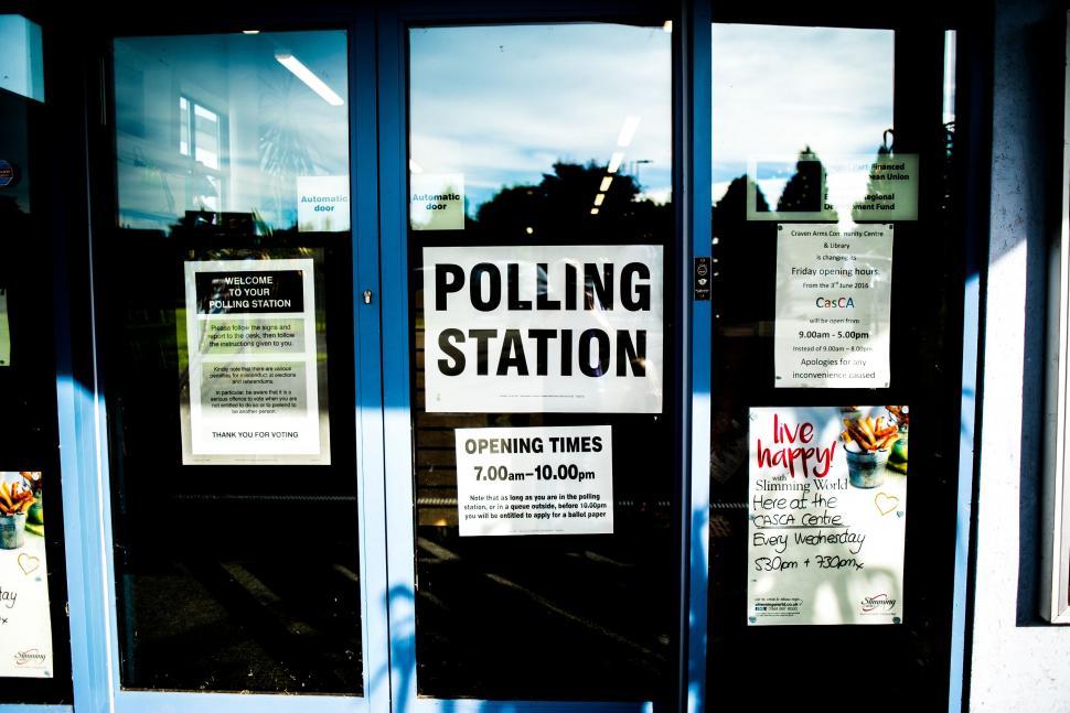 Free Image of Sign Posted on Glass Door 