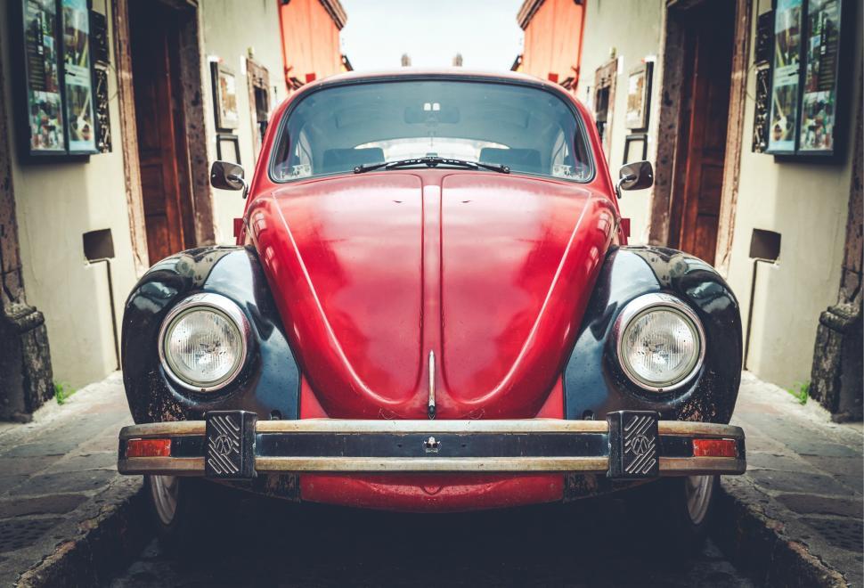 Free Image of Red Car Parked in Front of Building 