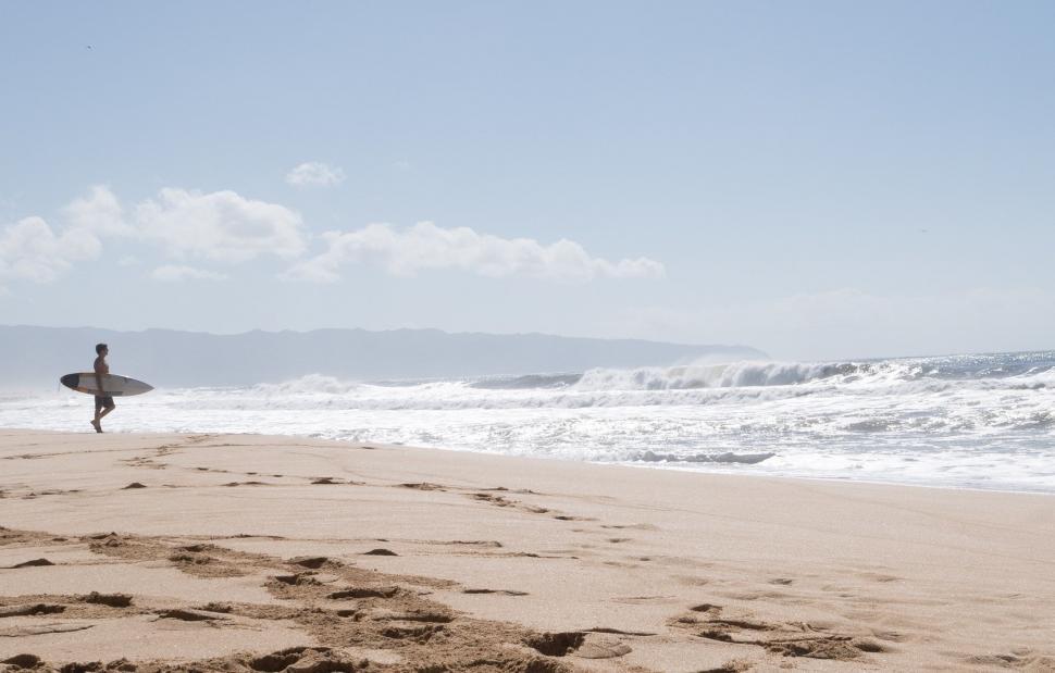 Free Image of Person Holding Surfboard on Sandy Beach 