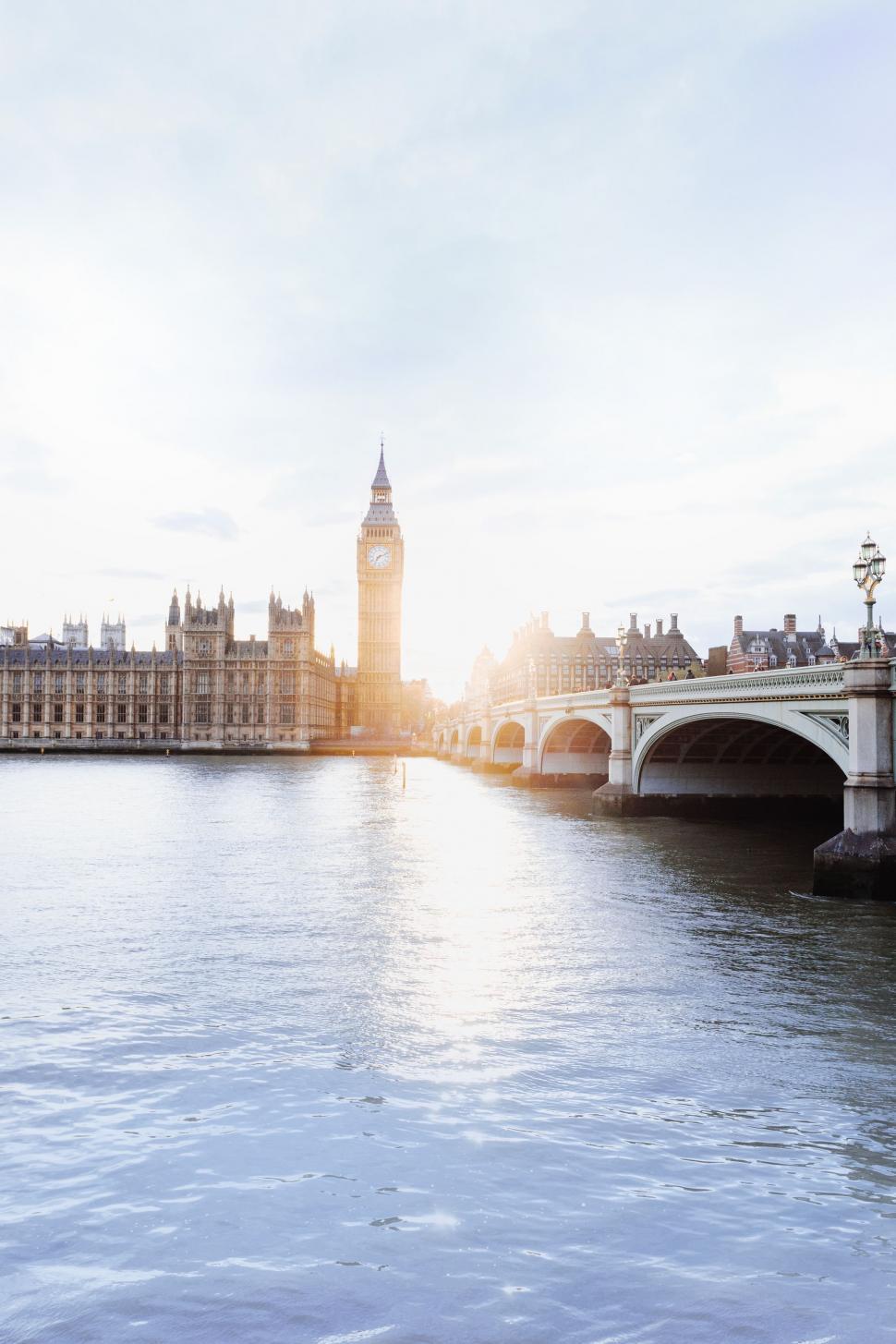 Free Image of Bridge Over Water With Clock Tower in Background 