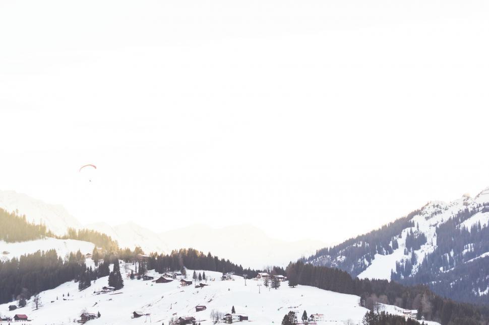 Free Image of Snow Covered Mountain With Ski Lift in Distance 