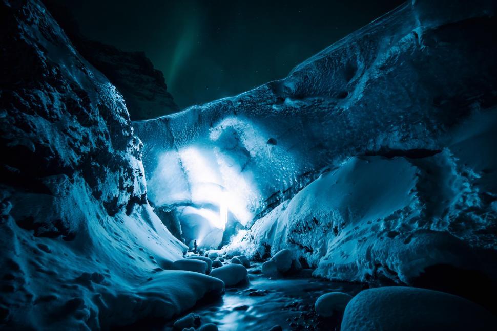 Free Image of A Dark Cave With a Stream Running Through It 
