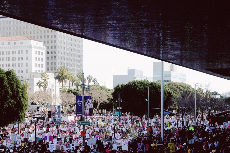 Free Image of Large Crowd of People Standing Under a Bridge 