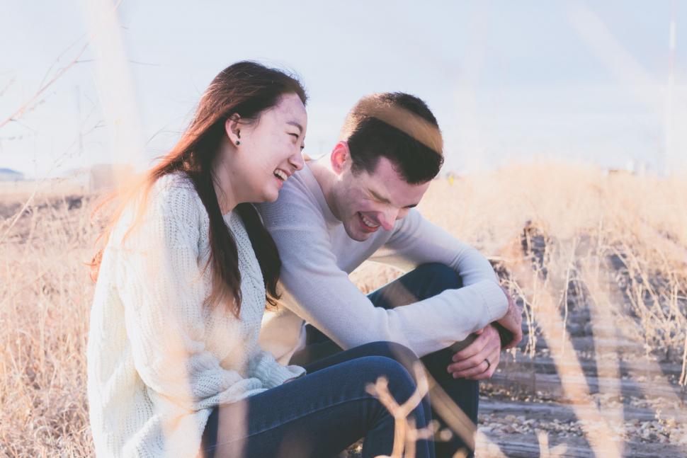 Free Image of Man and Woman Sitting on Train Track 