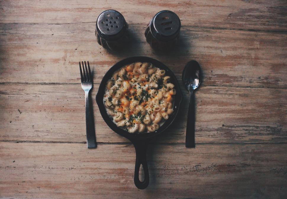 Free Image of Bowl of Cereal With Fork and Knife on Wooden Table 