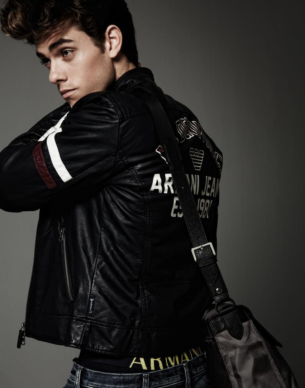 Free Image of Man in Leather Jacket Holding Handbag 