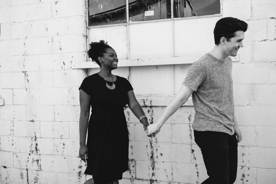 Free Image of A Man and a Woman Holding Hands 