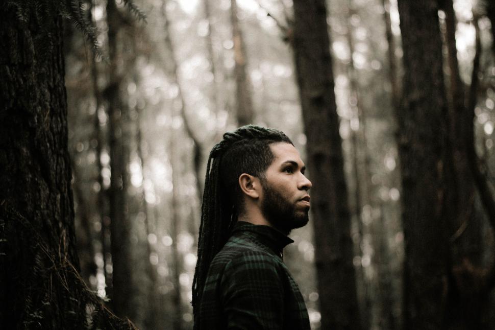 Free Image of Man With Long Hair Standing in Forest 