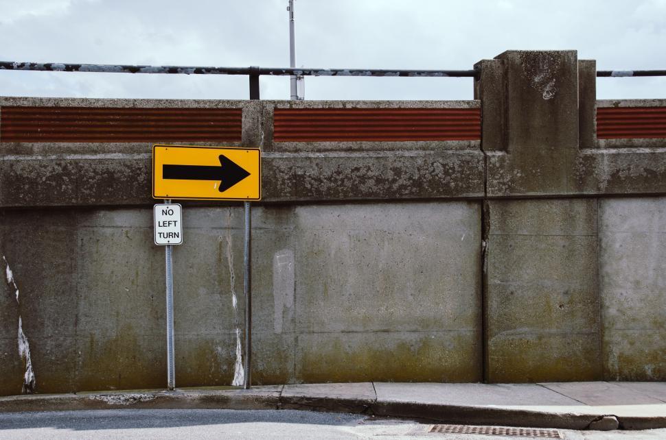 Free Image of Yellow Street Sign on Side of Road 