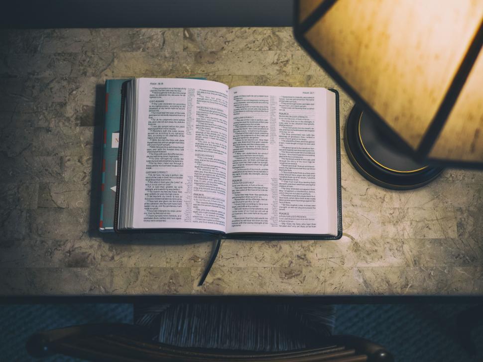 Free Image of Open Book on Table With Lamp 