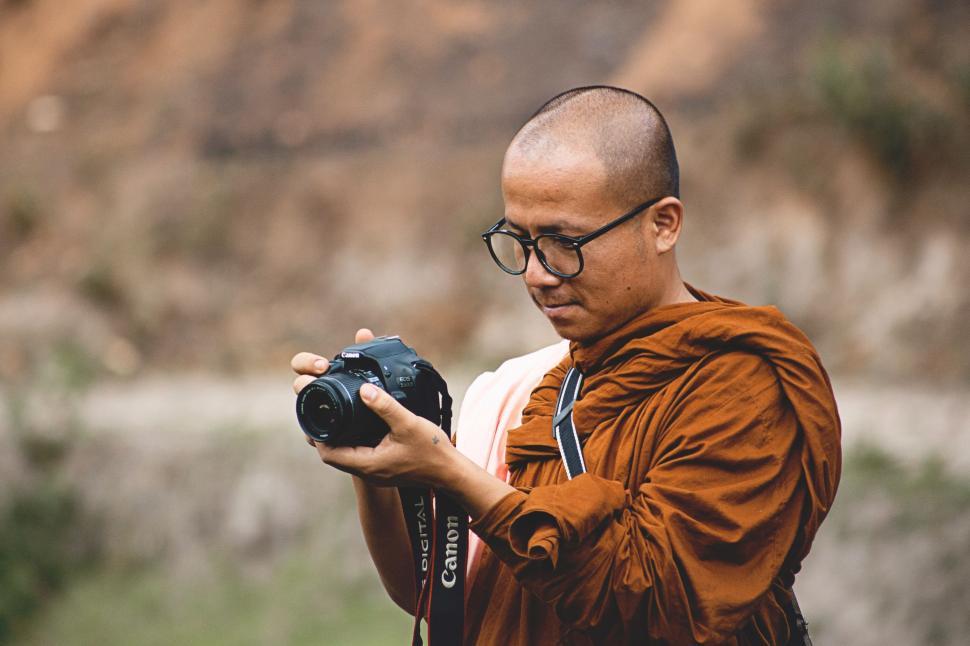 Free Image of Man Holding Camera Taking Picture 