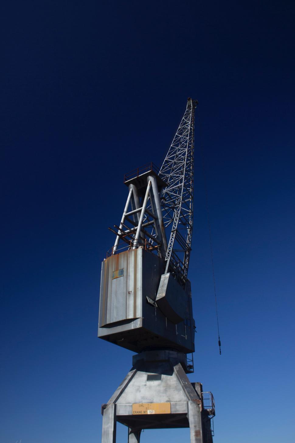 Free Image of Crane Perched on Cement Structure 