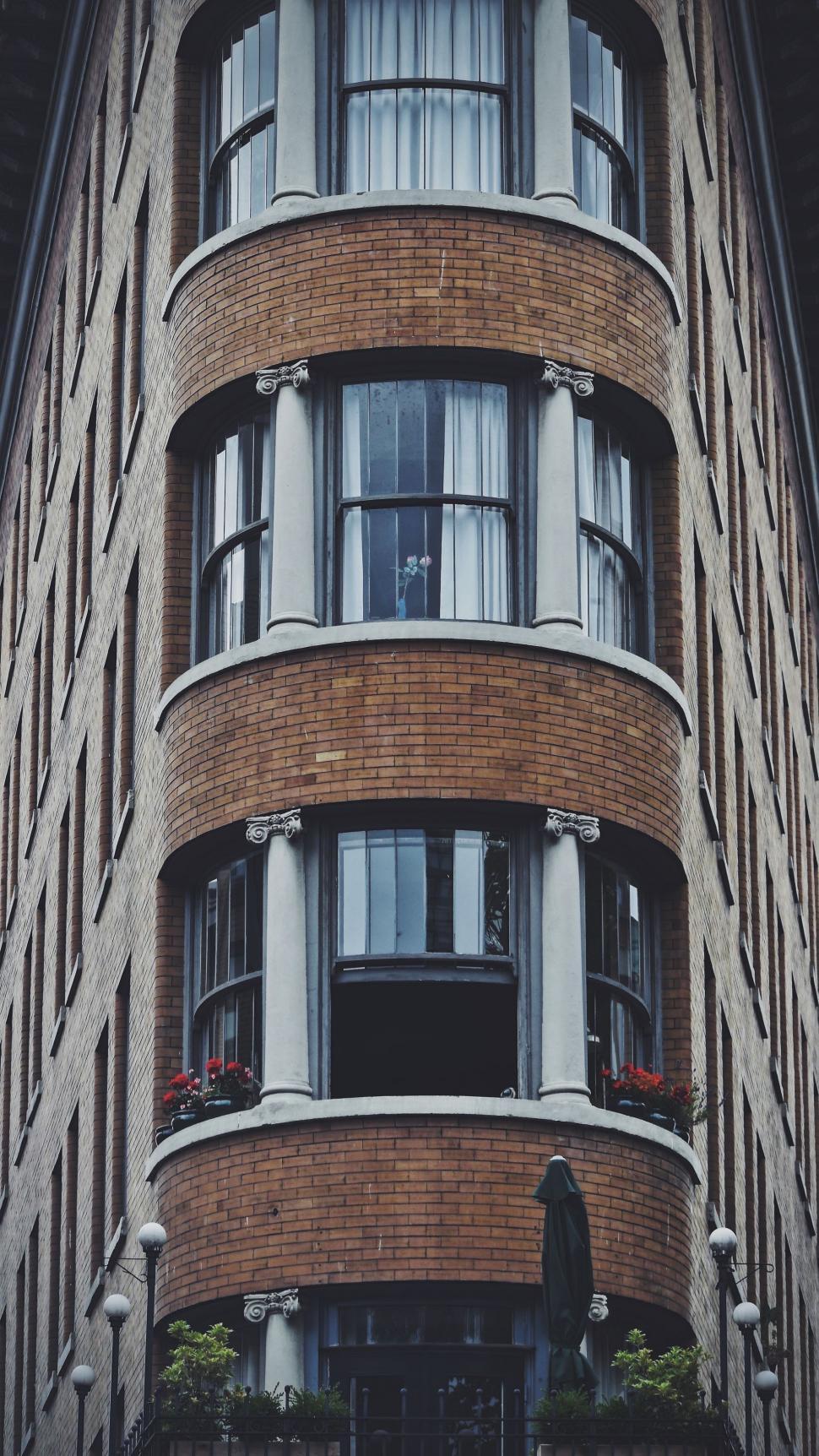 Free Image of Tall Brick Building With Lots of Windows 