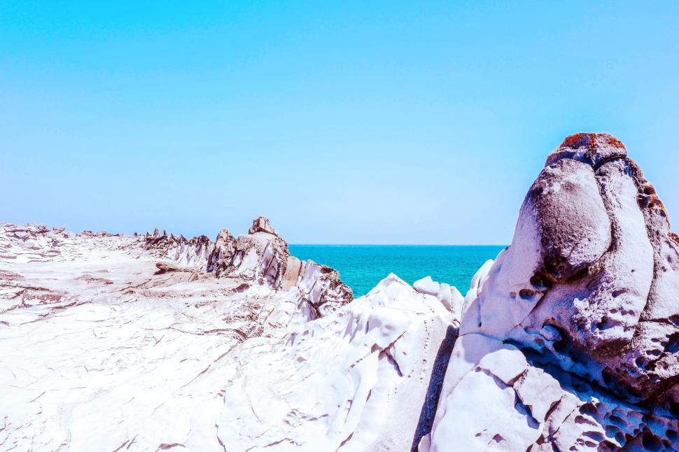 Free Image of Rock Formation Amid Beach 