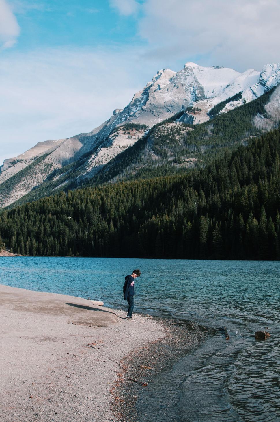 Free Image of Person Standing on Shore of Lake 