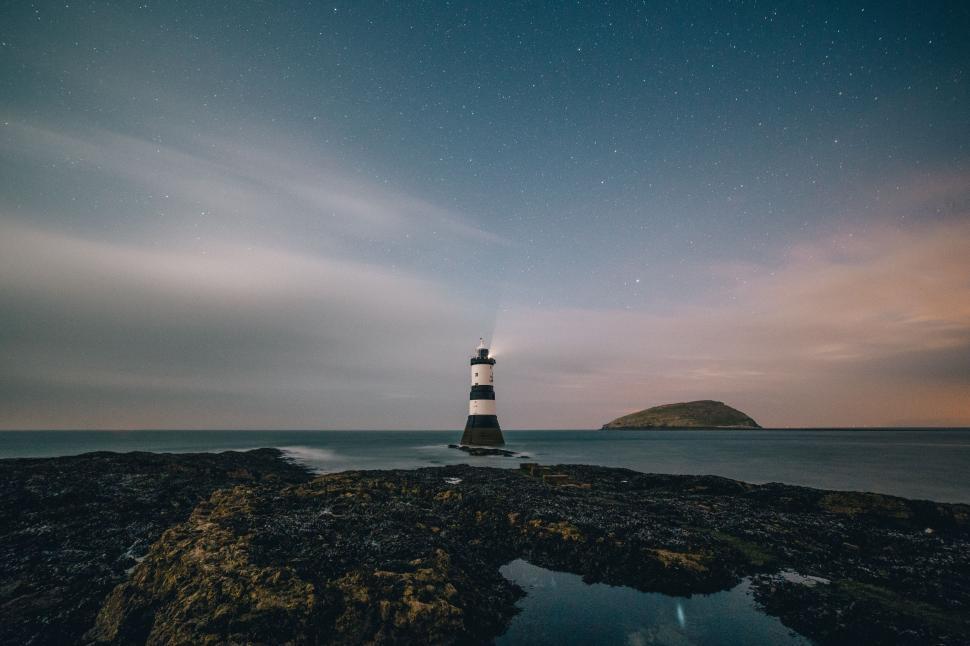 Free Image of Lighthouse Perched on Rocky Beach 