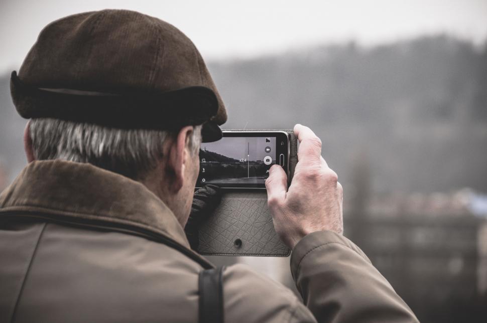 Free Image of Man Taking a Picture With a Camera 
