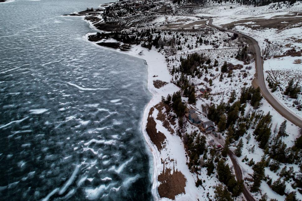 Free Image of Aerial View of Road Alongside Body of Water 