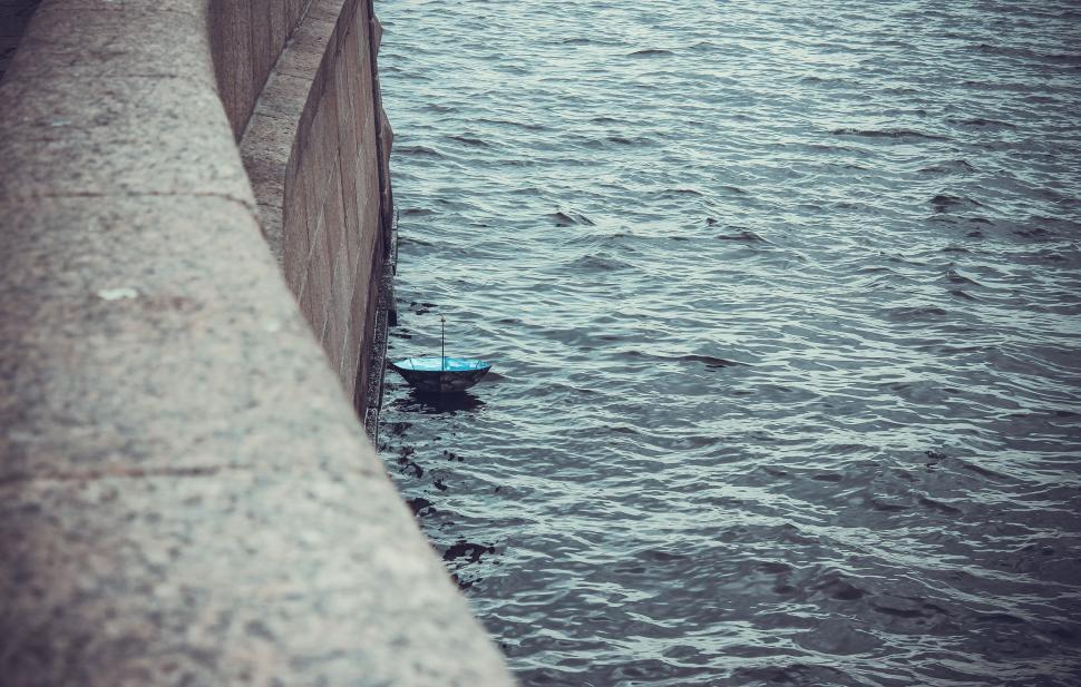 Free Image of Person Standing on Bridge Over Water 