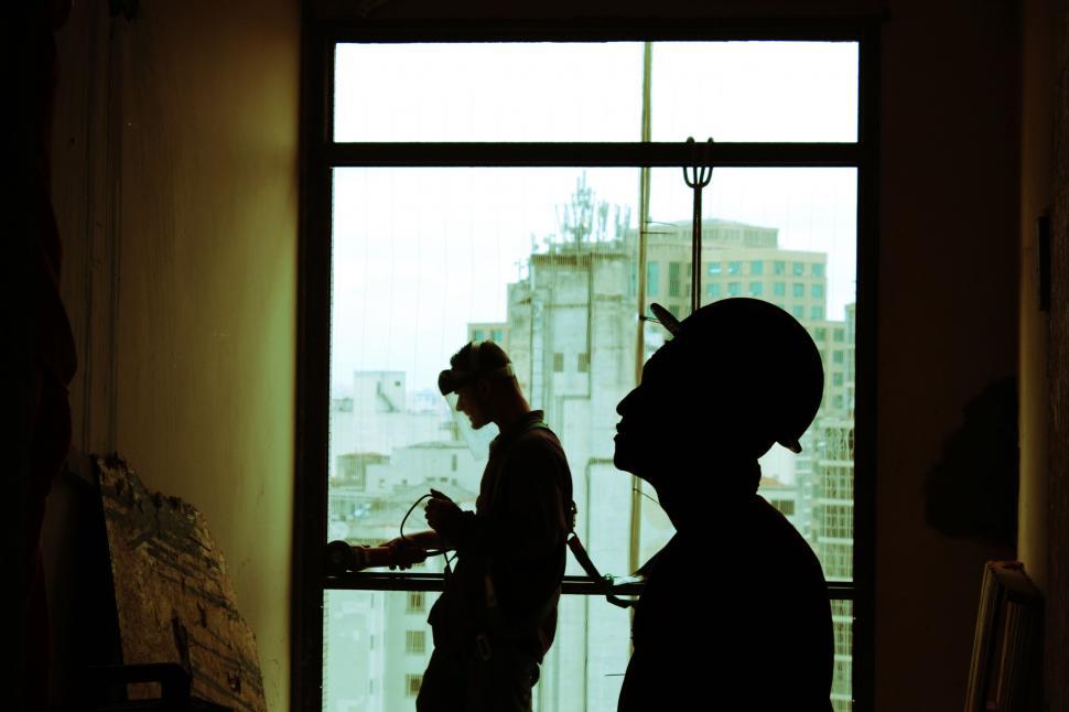 Free Image of Couple Standing Next to Window 