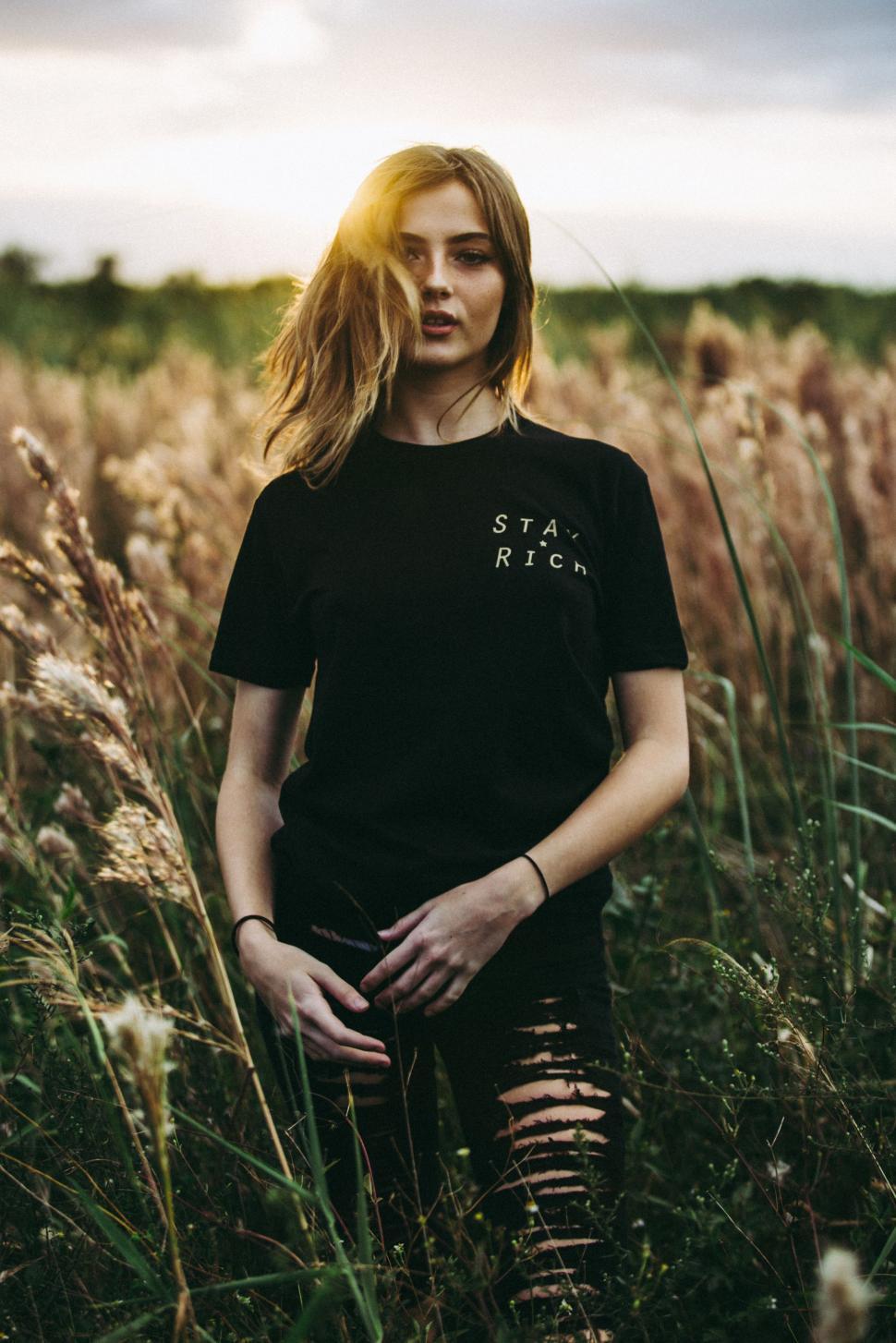 Free Image of Woman Standing in a Field of Tall Grass 