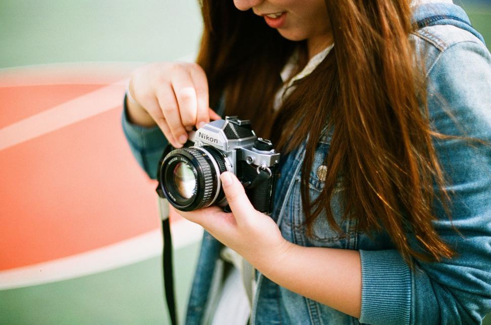 Free Image of Woman Taking a Picture With a Camera 