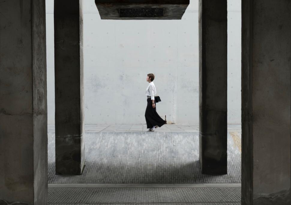 Free Image of Person Walking Under Bridge 