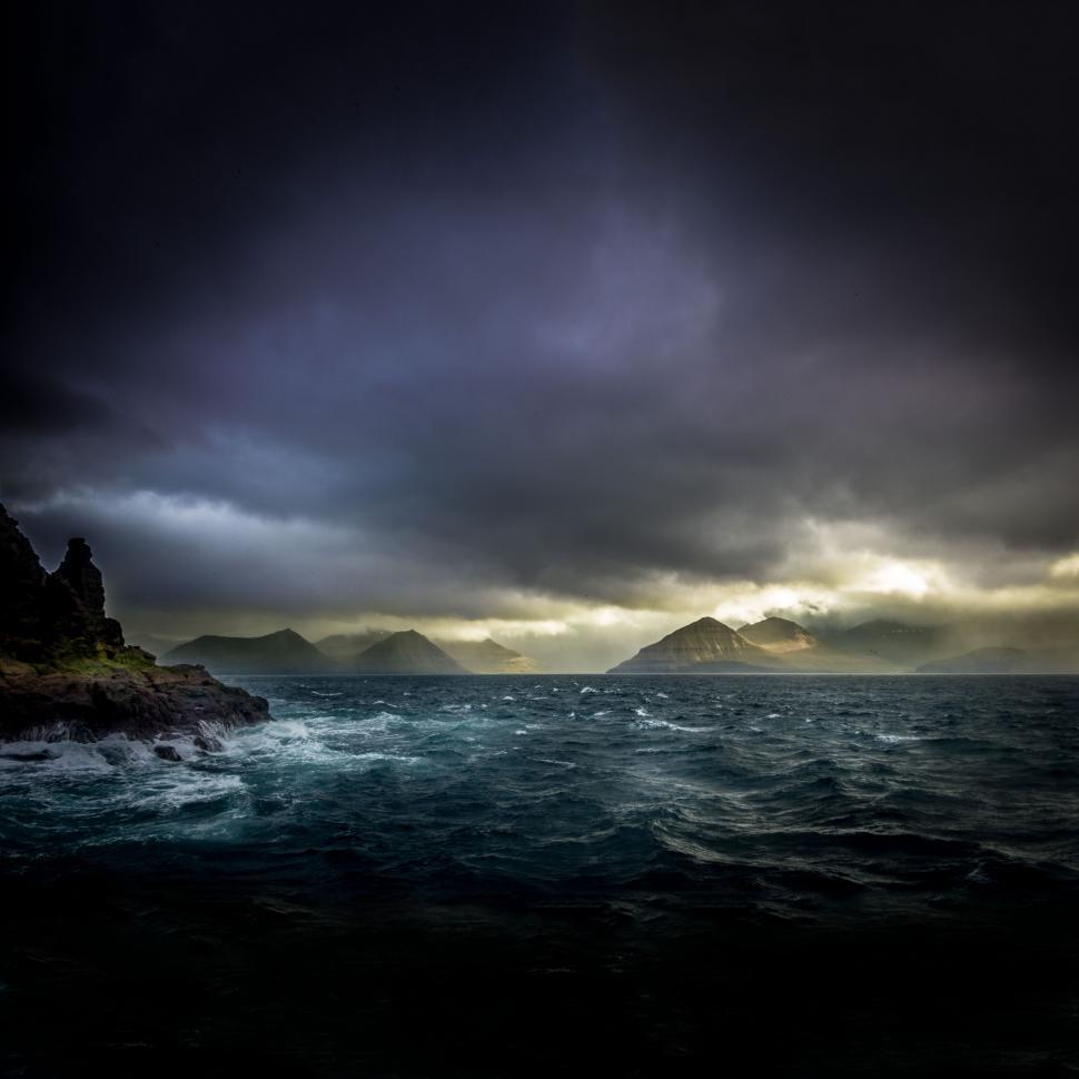 Free Image of Cloudy Sky Over Large Body of Water 