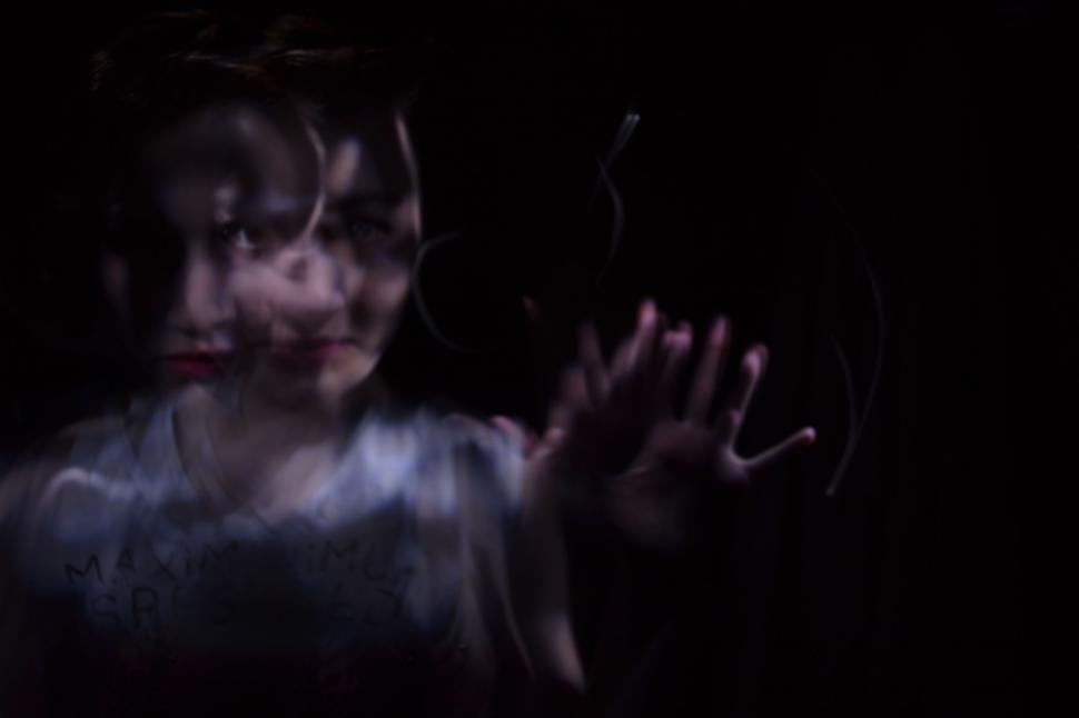 Free Image of Blurry Image of a Woman Holding Her Hands Up 