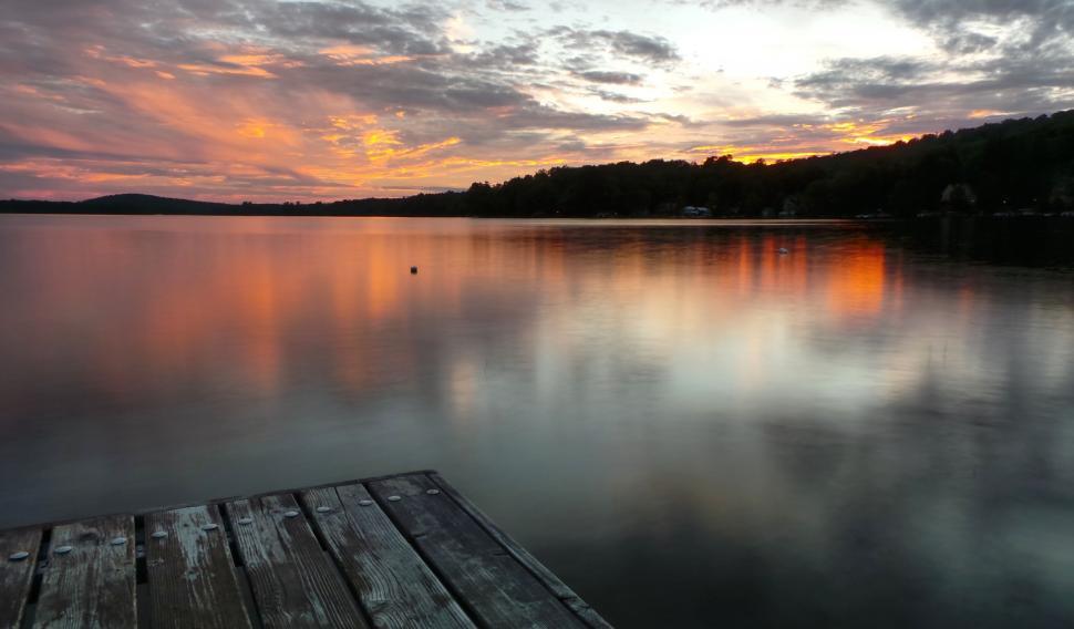 Free Image of Wooden Dock on Lake Under Cloudy Sky 