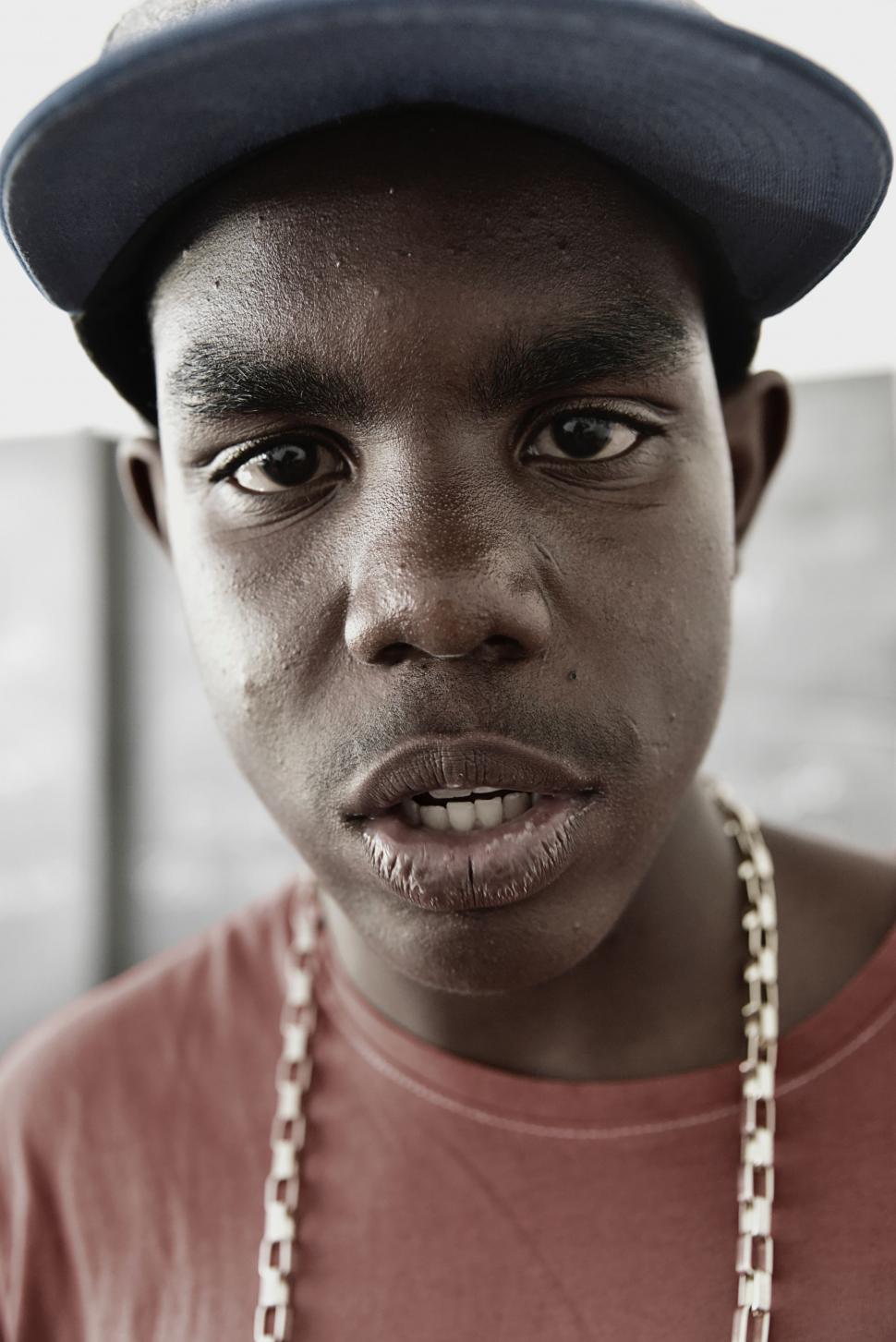 Free Image of Young Man Wearing a Hat and Chain Around His Neck 