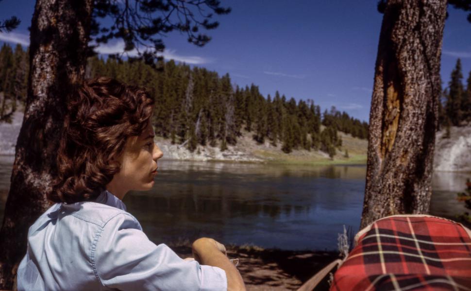 Free Image of Man and Woman Sitting by Lake 