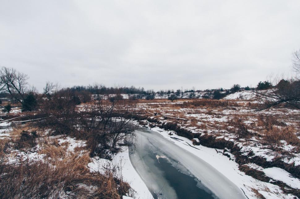 Free Image of Snow Covered Field With Small Pond 