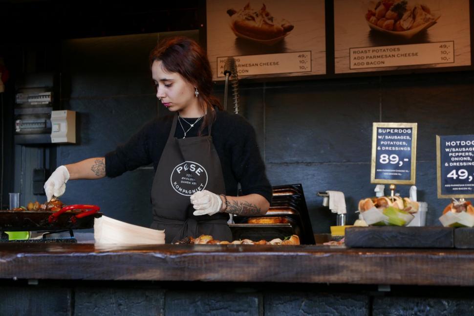 Free Image of Woman Preparing Food in Restaurant Kitchen 