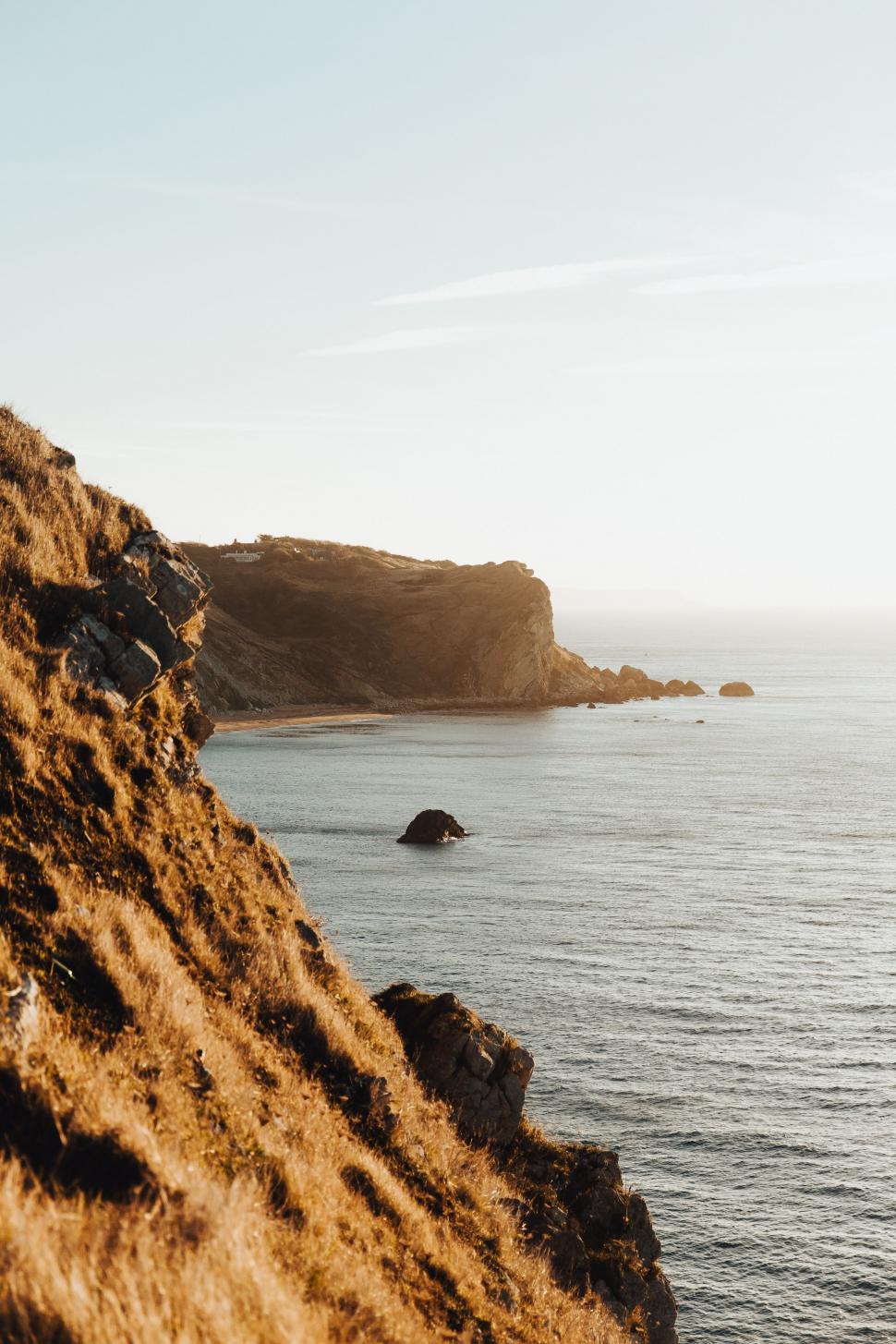 Free Image of Person Standing on Cliff Overlooking Ocean 