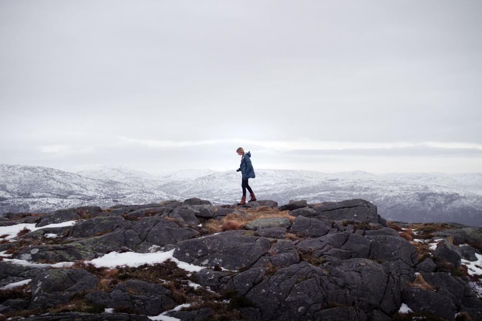 Free Image of Man Standing on Top of Rocky Mountain 