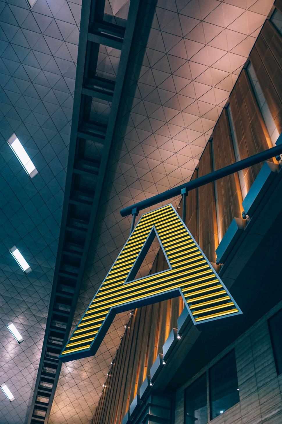 Free Image of Sign Hanging From the Side of a Building 