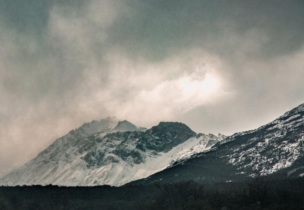 Free Image of Snow-Covered Mountain Under Cloudy Sky 