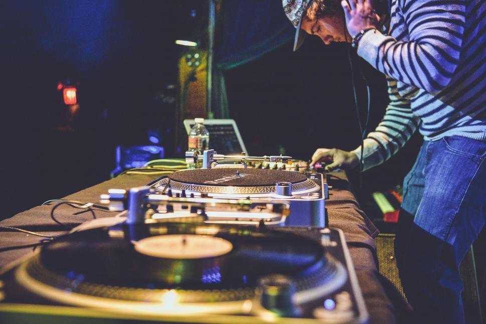 Free Image of Man Standing Next to Table With Record Player 