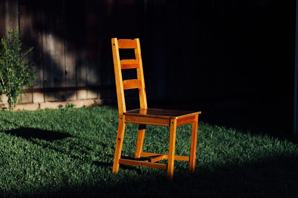 Free Image of Wooden Chair on Lush Green Field 