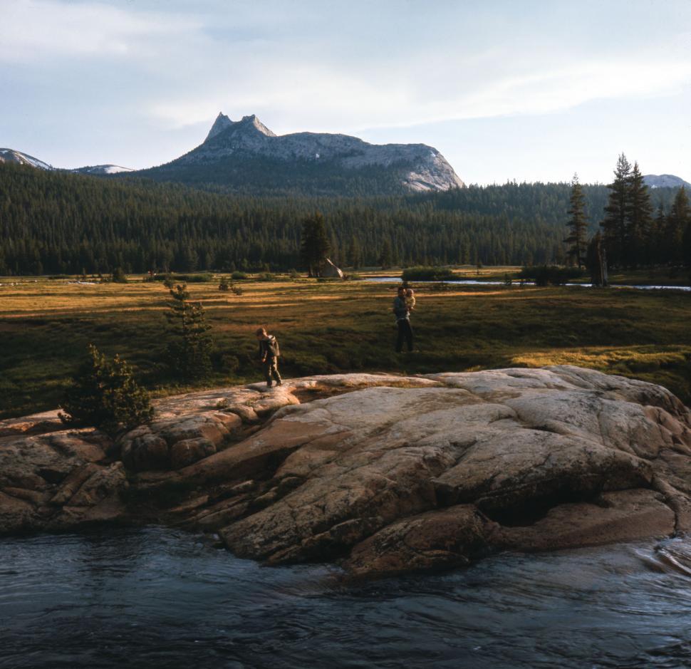 Free Image of Man Standing on Rock by River 