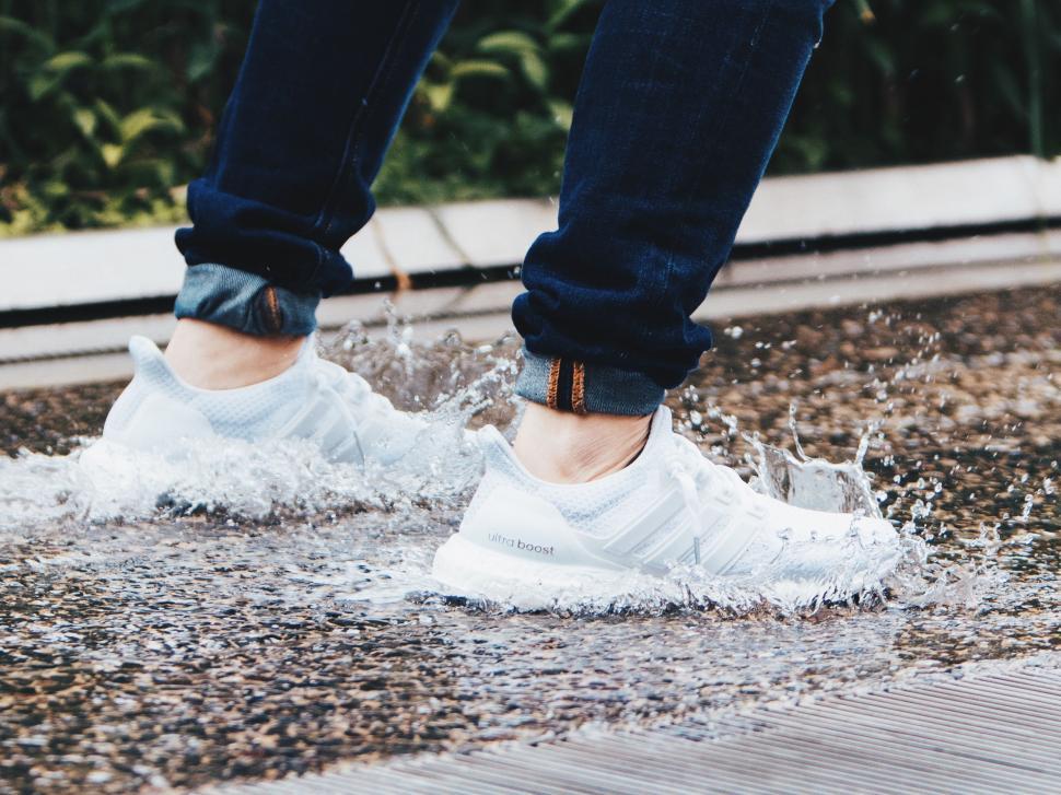 Free Image of Person Standing in Puddle of Water 