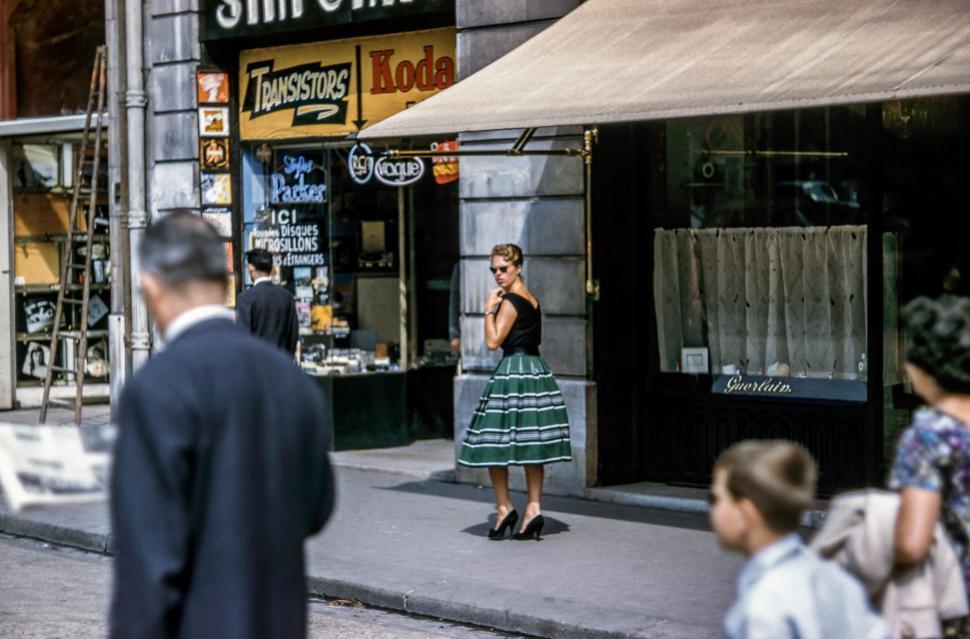 Free Image of Woman in Green and White Dress Talking on Cell Phone 