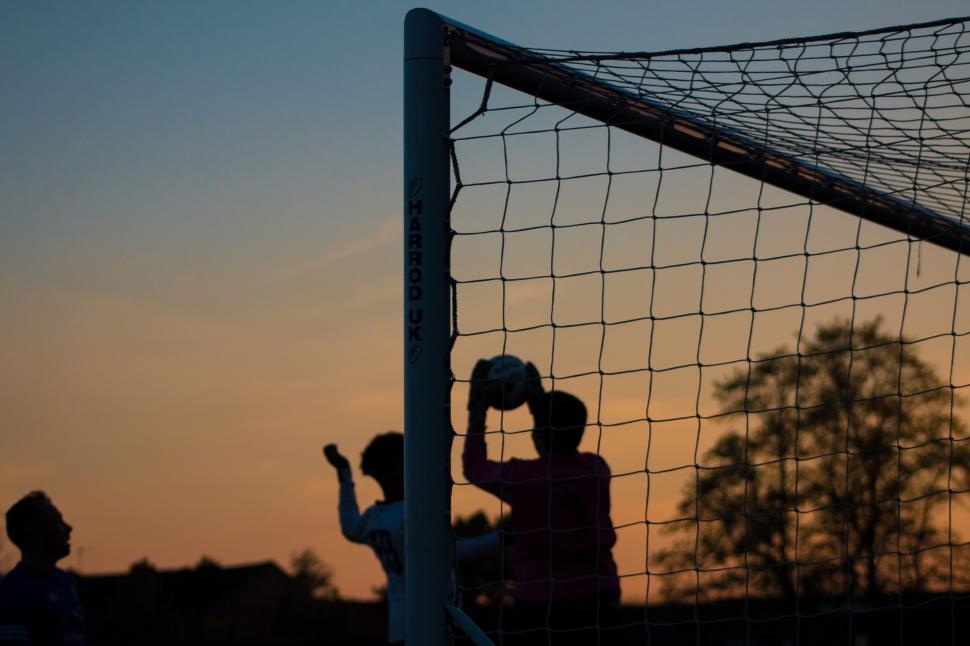 Free Image of Couple Standing in Front of Net 